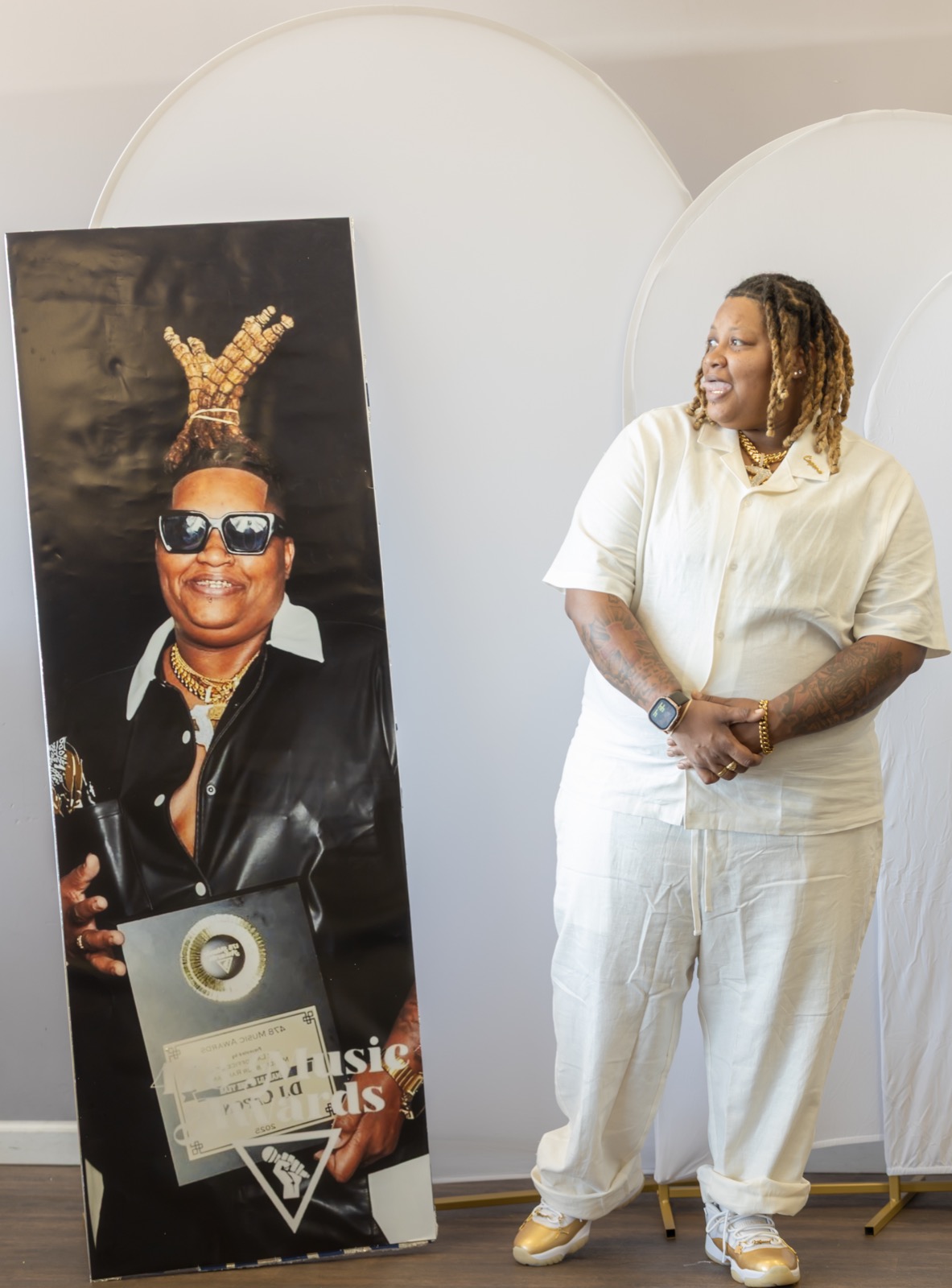 DJ Dior Capone next to her 478 Music Awards portrait